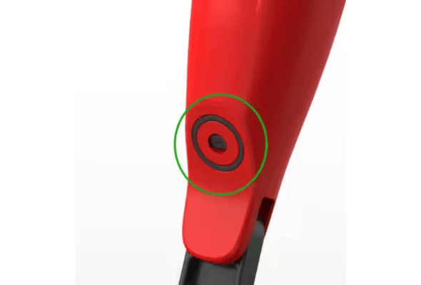 Close-up of red mop handle with a focus on the button area
