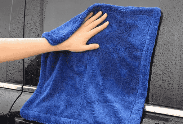 Hand using blue towel