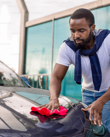Man Cleaning Car with Cloth